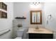 Quaint bathroom with framed prints, storage shelf, and a single sink vanity at 4970 Lost Mountain Nw Trce, Kennesaw, GA 30152