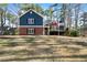 Charming two-story home with brick and blue siding, set on a spacious lawn with mature trees at 4970 Lost Mountain Nw Trce, Kennesaw, GA 30152