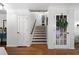Bright foyer with decorative wreath on the door and hardwood flooring leading up to the second story at 4970 Lost Mountain Nw Trce, Kennesaw, GA 30152