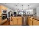 Open-concept kitchen with stainless steel appliances, granite counters, and seamless access to the living area at 4970 Lost Mountain Nw Trce, Kennesaw, GA 30152