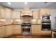 Well-equipped kitchen with stainless steel appliances, custom cabinets, and granite countertops at 4970 Lost Mountain Nw Trce, Kennesaw, GA 30152