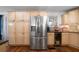 Modern kitchen featuring stainless steel refrigerator, ample cabinet space, and granite countertops at 4970 Lost Mountain Nw Trce, Kennesaw, GA 30152