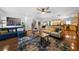 Open living room featuring hardwood floors, comfortable sofas, and an open kitchen layout at 4970 Lost Mountain Nw Trce, Kennesaw, GA 30152