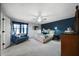 Cozy main bedroom with an accent wall, ceiling fan, carpeted flooring, and a sitting area at 4970 Lost Mountain Nw Trce, Kennesaw, GA 30152