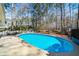 Large in-ground swimming pool is surrounded by spacious decking, with lounge chairs at 4970 Lost Mountain Nw Trce, Kennesaw, GA 30152