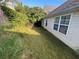Exterior backyard view with white fence, lush grass, and mature foliage at 536 Highland Falls Dr, Hiram, GA 30141