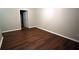 Bedroom with hardwood floors, neutral walls, white trim and an open door at 536 Highland Falls Dr, Hiram, GA 30141