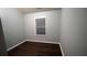 Bedroom features hardwood floors, a bright window and neutral walls at 536 Highland Falls Dr, Hiram, GA 30141