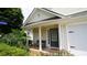 Inviting home entrance with columns, a bench, and colorful landscaping at 536 Highland Falls Dr, Hiram, GA 30141