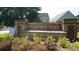 Stone entrance sign with 'Highland Falls' inscription surrounded by plants at 536 Highland Falls Dr, Hiram, GA 30141