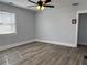 Spacious bedroom featuring wood-look floors, a ceiling fan, and a large window at 386 Sawtell Se Ave, Atlanta, GA 30315