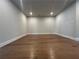 Finished basement with hardwood floors, pot lights, and ample space for recreation or storage at 400 Renwood Trl, Johns Creek, GA 30097