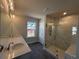 Luxurious bathroom featuring double sinks, a large walk-in shower with designer tile, and modern lighting at 400 Renwood Trl, Johns Creek, GA 30097