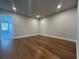 Spacious bedroom with gleaming hardwood floors and natural light from the view to the backyard at 400 Renwood Trl, Johns Creek, GA 30097