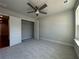 Bedroom with a ceiling fan, and carpeted floors, plus an adjacent closet at 400 Renwood Trl, Johns Creek, GA 30097