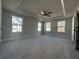Bright primary bedroom features plush carpet, a ceiling fan, and a tray ceiling at 400 Renwood Trl, Johns Creek, GA 30097