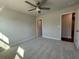 Open-concept bedroom with a ceiling fan, and plush carpets offers a airy feel at 400 Renwood Trl, Johns Creek, GA 30097