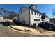 View of new construction townhome exterior featuring white brick, garage and paved driveway at 400 Renwood Trl, Johns Creek, GA 30097