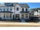 New construction two-story townhome showing front exterior with black trim windows and a landscaped yard at 400 Renwood Trl, Johns Creek, GA 30097