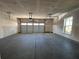 Spacious two car garage with an automatic garage door, bare drywall and high ceilings at 400 Renwood Trl, Johns Creek, GA 30097