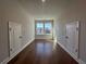 Hallway features hardwood flooring, natural lighting, two windows, and two storage closets at 400 Renwood Trl, Johns Creek, GA 30097