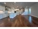 Open-concept living room featuring hardwood floors, large windows and seamless access to the kitchen at 400 Renwood Trl, Johns Creek, GA 30097