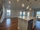 Bright living room and kitchen featuring hardwood floors, neutral colors and recessed lighting at 400 Renwood Trl, Johns Creek, GA 30097