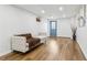 Finished basement featuring light wood floors, white walls, and a cozy couch, perfect for a relaxing living space at 5901 Miller Rd, Austell, GA 30106