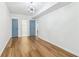 Stylish bedroom with wood floors and blue doors, enhanced by modern lighting, providing comfort and sophistication at 5901 Miller Rd, Austell, GA 30106