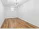 Bright bedroom featuring wood floors, a modern chandelier, and ample natural light from the window, creating a cozy retreat at 5901 Miller Rd, Austell, GA 30106