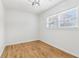 Cozy bedroom featuring hardwood floors, natural light, and neutral walls at 5901 Miller Rd, Austell, GA 30106