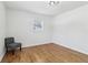 Comfortable bedroom featuring wood floors, a window with natural light, and a chair at 5901 Miller Rd, Austell, GA 30106