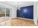 Dining area showcasing hardwood floors, modern lighting, and access to the outdoor deck at 5901 Miller Rd, Austell, GA 30106