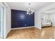 Bright dining room featuring hardwood floors, modern lighting, and a stylish accent wall at 5901 Miller Rd, Austell, GA 30106