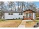 Charming white brick home with a welcoming covered porch and updated landscaping at 5901 Miller Rd, Austell, GA 30106