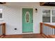 Close-up of the home's front entrance with a freshly painted green door and modern hardware at 5901 Miller Rd, Austell, GA 30106