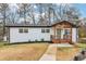 Charming single-story home with front porch, white brick exterior, and dark trim at 5901 Miller Rd, Austell, GA 30106