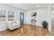 Inviting living room with hardwood floors, a front door, and large windows at 5901 Miller Rd, Austell, GA 30106