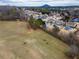 An aerial view shows a neighborhood with houses, green spaces, and a distant mountain view at 820 Nob Ridge Dr, Marietta, GA 30064