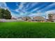 Expansive backyard with lush green lawn showcasing the house and pond, offering ample space for recreation and relaxation at 820 Nob Ridge Dr, Marietta, GA 30064