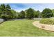 Expansive backyard with lush lawn, mature trees, privacy fence, and manicured landscaping at 820 Nob Ridge Dr, Marietta, GA 30064