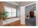 Bright bathroom features tiled jacuzzi tub and view to Primary bedroom at 820 Nob Ridge Dr, Marietta, GA 30064