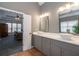 Modern bathroom features double sinks, gray cabinets and a view to the Primary bedroom at 820 Nob Ridge Dr, Marietta, GA 30064