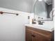 Charming half bathroom featuring beadboard paneling and a dark vanity with a bronze faucet at 820 Nob Ridge Dr, Marietta, GA 30064