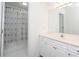 Bright bathroom with a white cabinet and a shower-tub combo and palm-themed curtain at 820 Nob Ridge Dr, Marietta, GA 30064