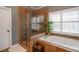 Bathroom features glass shower and jacuzzi tub with tiled walls and decor at 820 Nob Ridge Dr, Marietta, GA 30064