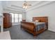 Bedroom featuring a tray ceiling, natural light, and dark carpet at 820 Nob Ridge Dr, Marietta, GA 30064