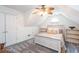 Bright bedroom with a queen bed, built-in shelves, neutral walls, and gray carpeting at 820 Nob Ridge Dr, Marietta, GA 30064