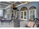 Cozy covered patio with ceiling fans, TV, wicker furniture, and a fire pit for outdoor relaxation and entertaining at 820 Nob Ridge Dr, Marietta, GA 30064