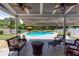 Outdoor patio with comfortable seating, ceiling fans, and a view of the backyard pool at 820 Nob Ridge Dr, Marietta, GA 30064